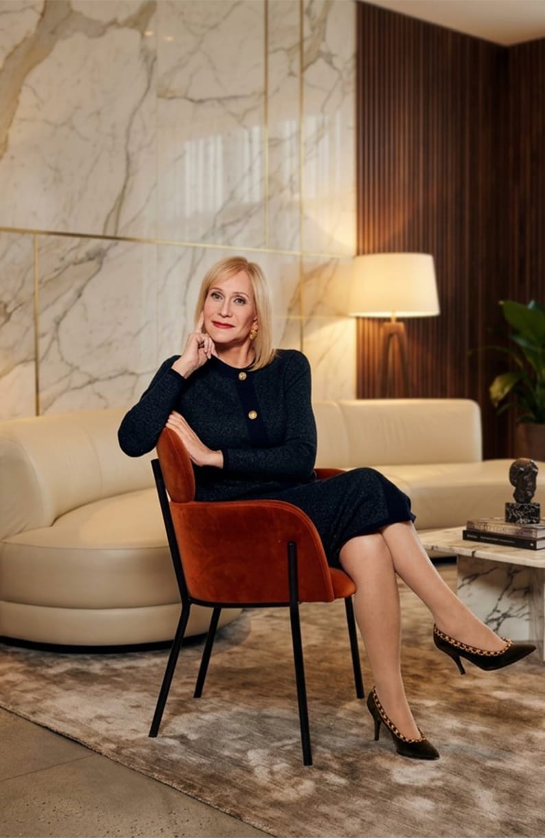 Lady in a formal dress sitting in a red chair in Dunwoody Georgia
